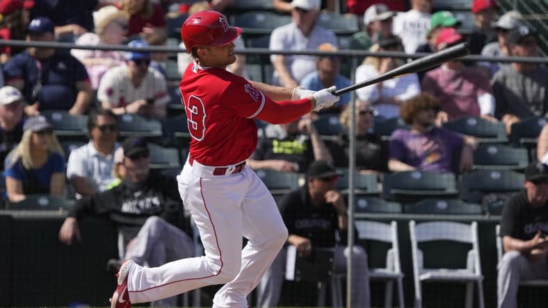 Mar 8, 2023; Tempe, Arizona, USA; Los Angeles Angels catcher Max Stassi (33) hits a single against the Colorado Rockies in the fourth inning at Tempe Diablo Stadium. Mandatory Credit: Rick Scuteri-USA TODAY Sports