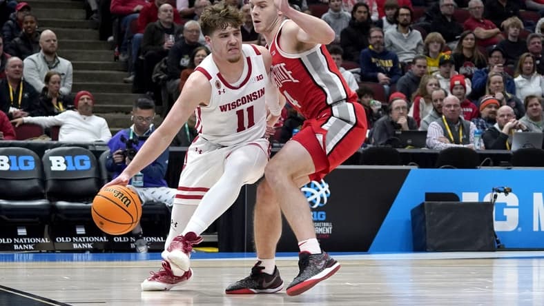 Mar 8, 2023; Chicago, IL, USA; Ohio State Buckeyes guard Sean McNeil (4) defends Wisconsin Badgers guard Max Klesmit (11) during the first half at United Center. Mandatory Credit: David Banks-USA TODAY Sports