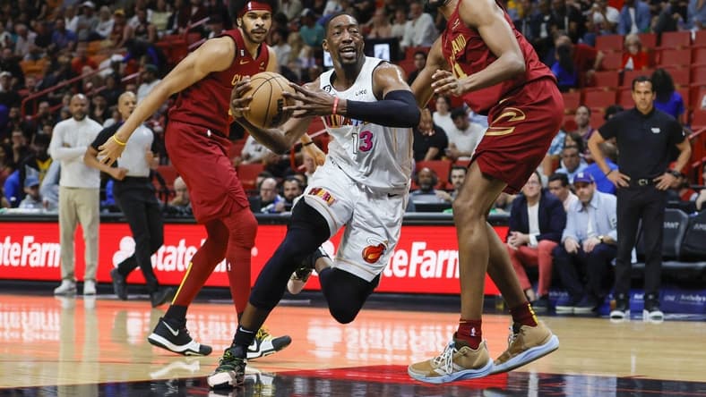 Mar 8, 2023; Miami, Florida, USA; Miami Heat center Bam Adebayo (13) drives to the basket ahead of Cleveland Cavaliers center Jarrett Allen (31) and forward Evan Mobley (4) during the first quarter at Miami-Dade Arena. Mandatory Credit: Sam Navarro-USA TODAY Sports