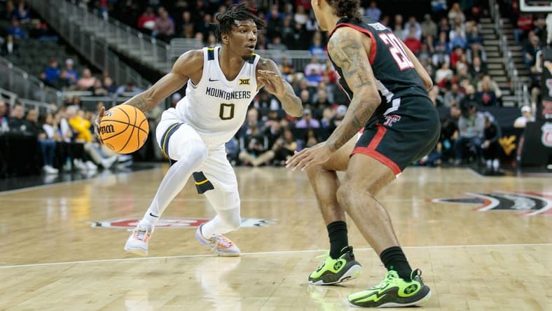 Mar 8, 2023; Kansas City, MO, USA; West Virginia Mountaineers guard Kedrian Johnson (0) drives to the basket around Texas Tech Red Raiders guard Jaylon Tyson (20) during the first half at T-Mobile Center. Mandatory Credit: William Purnell-USA TODAY Sports