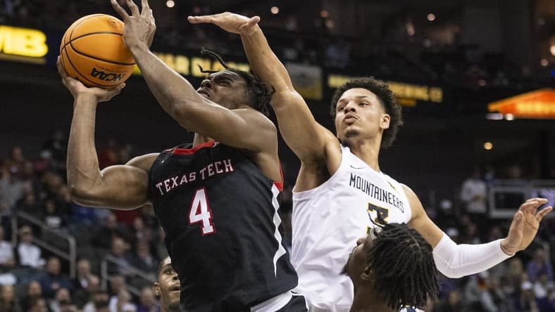 Mar 8, 2023; Kansas City, MO, USA; Texas Tech Red Raiders forward Robert Jennings (4) shoots the ball while defended by West Virginia Mountaineers forward Tre Mitchell (3) in the first half at T-Mobile Center. Mandatory Credit: Amy Kontras-USA TODAY Sports