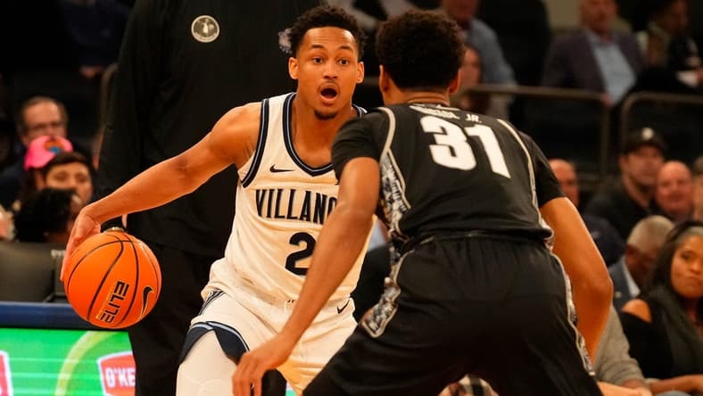 Mar 8, 2023; New York, NY, USA; Villanova Wildcats guard Mark Armstrong (2) drives against Georgetown Hoyas guard Wayne Bristol Jr. (31) as Georgetown Hoyas head coach Patrick Ewing watches at rear at Madison Square Garden. Mandatory Credit: Robert Deutsch-USA TODAY Sports