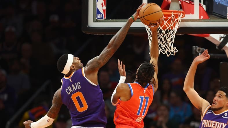 Mar 8, 2023; Phoenix, Arizona, USA; Phoenix Suns forward Torrey Craig (0) blocks the shot of Oklahoma City Thunder guard Isaiah Joe (11) in the first half at Footprint Center. Mandatory Credit: Mark J. Rebilas-USA TODAY Sports
