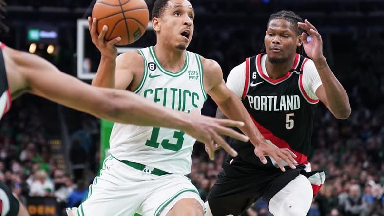 Mar 8, 2023; Boston, Massachusetts, USA; Boston Celtics guard Malcolm Brogdon (13) drives the ball against Portland Trail Blazers forward Cam Reddish (5) in the second half at TD Garden. Mandatory Credit: David Butler II-USA TODAY Sports
