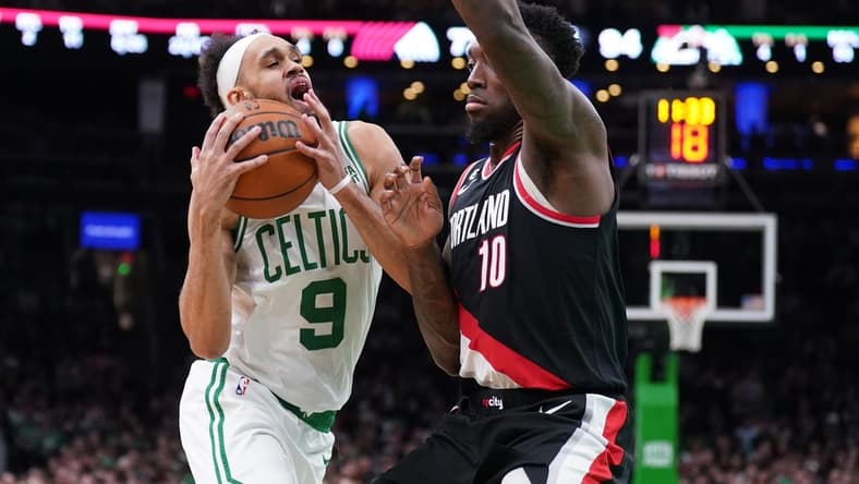 Mar 8, 2023; Boston, Massachusetts, USA; Boston Celtics guard Derrick White (9) drives the ball against Portland Trail Blazers forward Nassir Little (10) in the second half at TD Garden. Mandatory Credit: David Butler II-USA TODAY Sports
