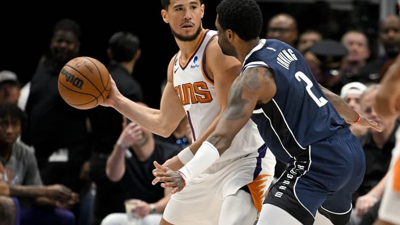 Mar 5, 2023; Dallas, Texas, USA; Phoenix Suns guard Devin Booker (1) and Dallas Mavericks guard Kyrie Irving (2) in action during the game between the Dallas Mavericks and the Phoenix Suns at the American Airlines Center. Mandatory Credit: Jerome Miron-USA TODAY Sports