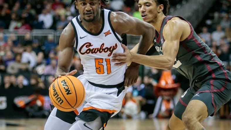 Mar 8, 2023; Kansas City, MO, USA; Oklahoma State Cowboys guard John-Michael Wright (51) drives to the basket during the first half against the Oklahoma Sooners at T-Mobile Center. Mandatory Credit: William Purnell-USA TODAY Sports