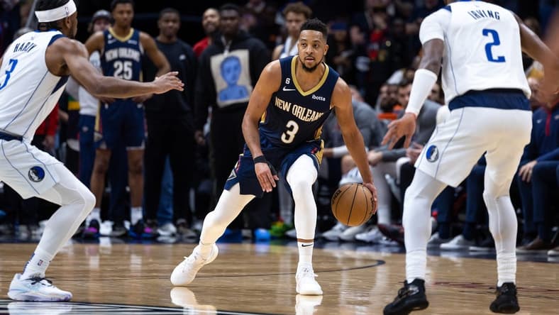 Mar 8, 2023; New Orleans, Louisiana, USA;  New Orleans Pelicans guard CJ McCollum (3) brings the ball up court against Dallas Mavericks guard Kyrie Irving (2) and guard Jaden Hardy (3) during the second half at Smoothie King Center. Mandatory Credit: Stephen Lew-USA TODAY Sports