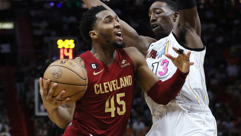 Mar 8, 2023; Miami, Florida, USA; Cleveland Cavaliers guard Donovan Mitchell (45) drives to the basket against Miami Heat center Bam Adebayo (13) during the third quarter at Miami-Dade Arena. Mandatory Credit: Sam Navarro-USA TODAY Sports