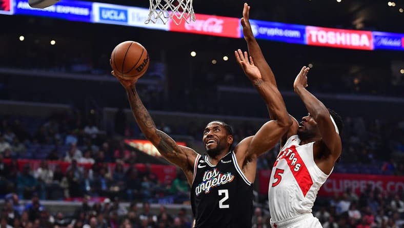 Mar 8, 2023; Los Angeles, California, USA; Los Angeles Clippers forward Kawhi Leonard (2) moves to the basket against Toronto Raptors forward Will Barton (5) during the first half at Crypto.com Arena. Mandatory Credit: Gary A. Vasquez-USA TODAY Sports