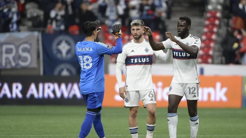 Mar 8, 2023; Vancouver, British Columbia, CAN; Vancouver Whitecaps FC goalkeeper Yohei Takaoka (18) celebrates the win with defender Tristan Blackmon (6) and defender Karifa Yao (12) during the second half at BC Place Stadium. Mandatory Credit: Anne-Marie Sorvin-USA TODAY Sports