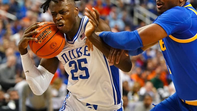 Mar 9, 2023; Greensboro, NC, USA; Duke Blue Devils forward Mark Mitchell (25) drives to the basket against Pittsburgh Panthers forward Blake Hinson (2) during the first half of the quarterfinals of the ACC tournament at Greensboro Coliseum. Mandatory Credit: John David Mercer-USA TODAY Sports