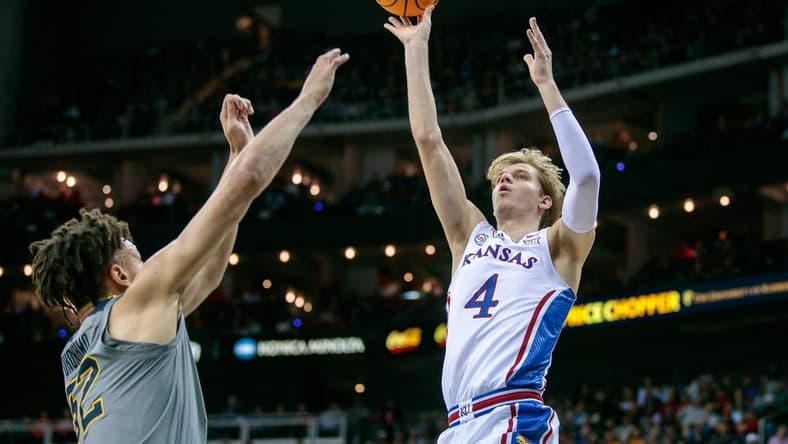 Mar 9, 2023; Kansas City, MO, USA; Kansas Jayhawks guard Gradey Dick (4) puts up a shot over West Virginia Mountaineers forward James Okonkwo (32) during the first half at T-Mobile Center. Mandatory Credit: William Purnell-USA TODAY Sports