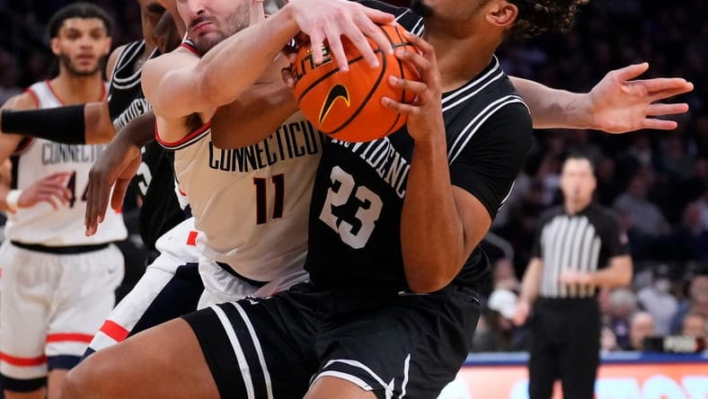 Mar 9, 2023; New York, NY, USA; Connecticut Huskies forward Alex Karaban (11) ties up Providence Friars forward Bryce Hopkins (23) in the second half at Madison Square Garden. Mandatory Credit: Robert Deutsch-USA TODAY Sports