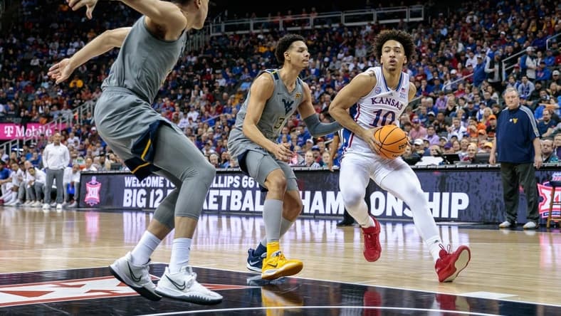 Mar 9, 2023; Kansas City, MO, USA; Kansas Jayhawks forward Jalen Wilson (10) moves to the basket around West Virginia Mountaineers forward Tre Mitchell (3) during the first half at T-Mobile Center. Mandatory Credit: William Purnell-USA TODAY Sports