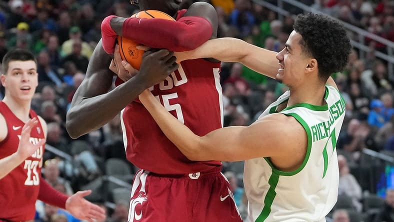 Mar 9, 2023; Las Vegas, NV, USA; Oregon Ducks guard Rivaldo Soares (11) attempts to steal the ball from Washington State Cougars center Adrame Diongue (15) during the first half at T-Mobile Arena. Mandatory Credit: Stephen R. Sylvanie-USA TODAY Sports