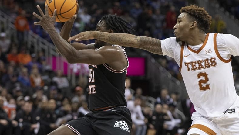 Mar 9, 2023; Kansas City, MO, USA; Oklahoma State Cowboys guard John-Michael Wright (51) handles the ball while defended by Texas Longhorns guard Arterio Morris (2) in the first half at T-Mobile Center. Mandatory Credit: Amy Kontras-USA TODAY Sports