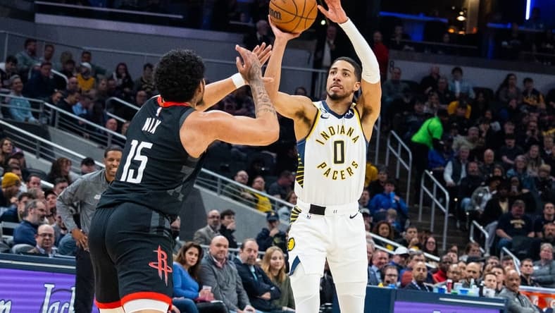 Mar 9, 2023; Indianapolis, Indiana, USA; Indiana Pacers guard Tyrese Haliburton (0) shoots the ball while Houston Rockets guard Daishen Nix (15) defends in the second quarter at Gainbridge Fieldhouse. Mandatory Credit: Trevor Ruszkowski-USA TODAY Sports