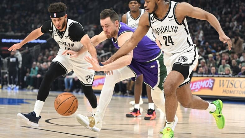 Mar 9, 2023; Milwaukee, Wisconsin, USA; Brooklyn Nets guards Seth Curry (30), left, and Cam Thomas (24) battle for the ball with Milwaukee Bucks guard Pat Connaughton (24) in the first half at Fiserv Forum. Mandatory Credit: Michael McLoone-USA TODAY Sports