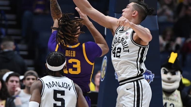 Mar 9, 2023; Nashville, TN, USA; Vanderbilt Commodores forward Quentin Millora-Brown (42) blocks a shot attempt by LSU Tigers forward Jalen Reed (13) during the first half at Bridgestone Arena. Mandatory Credit: Christopher Hanewinckel-USA TODAY Sports