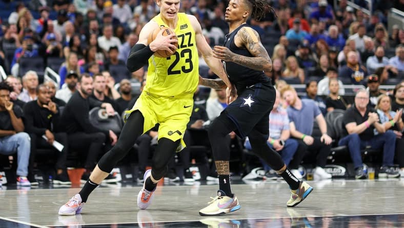 Mar 9, 2023; Orlando, Florida, USA;  Utah Jazz forward Lauri Markkanen (23) drives to the hope past Orlando Magic guard Markelle Fultz (20) in the fourth quarter at Amway Center. Mandatory Credit: Nathan Ray Seebeck-USA TODAY Sports