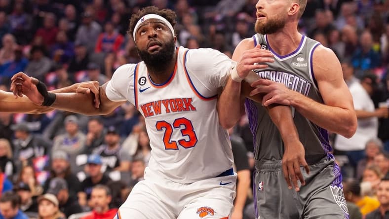 Mar 9, 2023; Sacramento, California, USA; New York Knicks center Mitchell Robinson (23) and Sacramento Kings forward Domantas Sabonis (10) fight for position under the basket during the first quarter at Golden 1 Center. Mandatory Credit: Ed Szczepanski-USA TODAY Sports