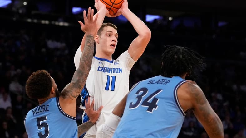 Mar 9, 2023; New York, NY, USA; Creighton Bluejays center Ryan Kalkbrenner (11) defended by Villanova Wildcats guard Justin Moore (5) and Villanova Wildcats forward Brandon Slater (34)  in the first half at Madison Square Garden. Mandatory Credit: Robert Deutsch-USA TODAY Sports