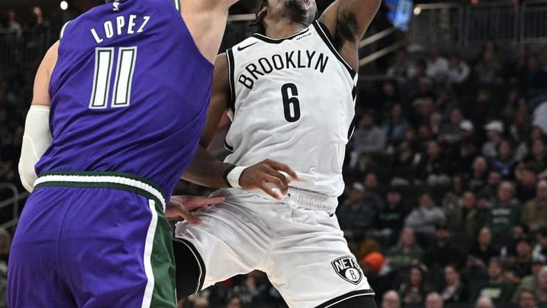 Mar 9, 2023; Milwaukee, Wisconsin, USA; Brooklyn Nets guard David Duke Jr. (6) drives to the basket against Milwaukee Bucks center Brook Lopez (11)  at Fiserv Forum. Mandatory Credit: Michael McLoone-USA TODAY Sports