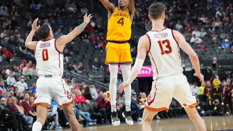 Mar 9, 2023; Las Vegas, NV, USA; Arizona State Sun Devils guard Desmond Cambridge Jr. (4) shoots against USC Trojans forward Kobe Johnson (0) during the first half at T-Mobile Arena. Mandatory Credit: Stephen R. Sylvanie-USA TODAY Sports