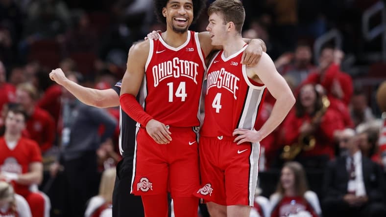 Mar 10, 2023; Chicago, IL, USA; Ohio State Buckeyes forward Justice Sueing (14) and guard Sean McNeil (4) celebrate teams win against the Michigan State Spartans at United Center. Mandatory Credit: Kamil Krzaczynski-USA TODAY Sports