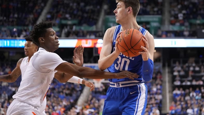 Mar 10, 2023; Greensboro, NC, USA; Duke Blue Devils center Kyle Filipowski (30) with the ball as Clemson Tigers guard Chase Hunter (1) defends in the first half during the semifinals of the ACC Tournament at Greensboro Coliseum. Mandatory Credit: Bob Donnan-USA TODAY Sports