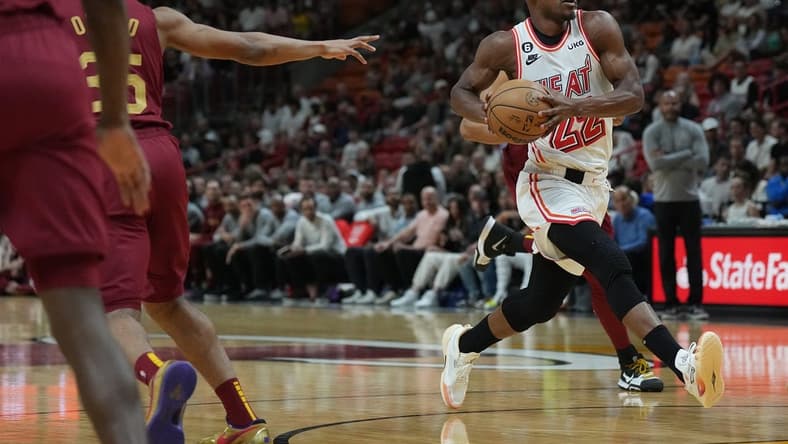 Mar 10, 2023; Miami, Florida, USA; Miami Heat forward Jimmy Butler (22) heads toward the basket as Cleveland Cavaliers forward Isaac Okoro (35) defends in the first half at Miami-Dade Arena. Mandatory Credit: Jim Rassol-USA TODAY Sports