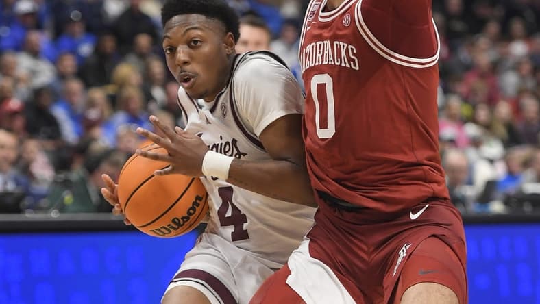 Mar 10, 2023; Nashville, TN, USA; Texas A&M Aggies guard Wade Taylor IV (4) drives past Arkansas Razorbacks guard Anthony Black (0) during the second half at Bridgestone Arena. Mandatory Credit: Steve Roberts-USA TODAY Sports