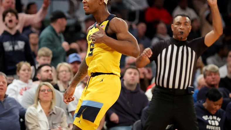 Mar 10, 2023; New York, NY, USA; Marquette Golden Eagles guard Chase Ross (5) reacts after making a three point shot against the Connecticut Huskies during the second half at Madison Square Garden. Mandatory Credit: Brad Penner-USA TODAY Sports