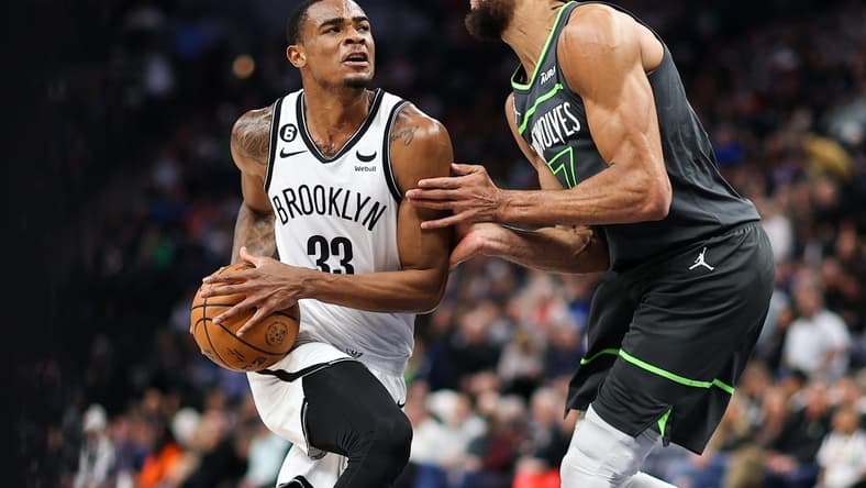 Mar 10, 2023; Minneapolis, Minnesota, USA; Brooklyn Nets center Nic Claxton (33) drives while Minnesota Timberwolves center Rudy Gobert (27) defends during the second quarter at Target Center. Mandatory Credit: Matt Krohn-USA TODAY Sports