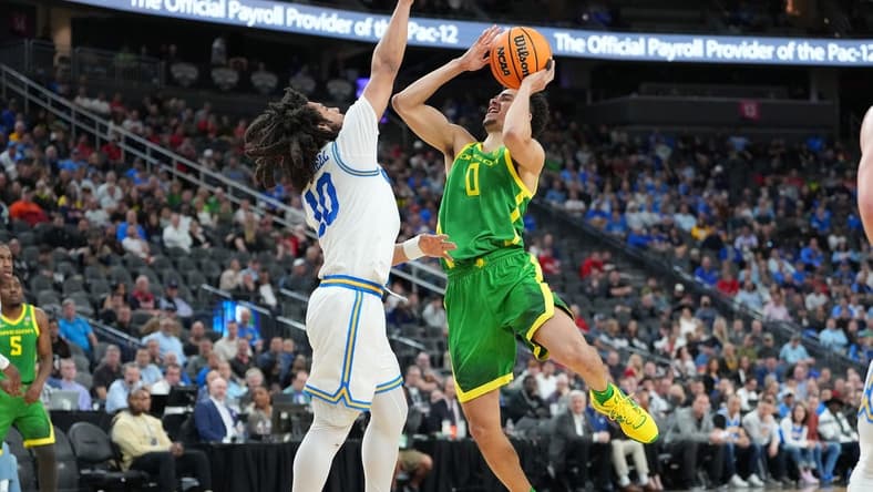 Mar 10, 2023; Las Vegas, NV, USA; Oregon Ducks guard Will Richardson (0) shoots against UCLA Bruins guard Tyger Campbell (10) during the first half at T-Mobile Arena. Mandatory Credit: Stephen R. Sylvanie-USA TODAY Sports