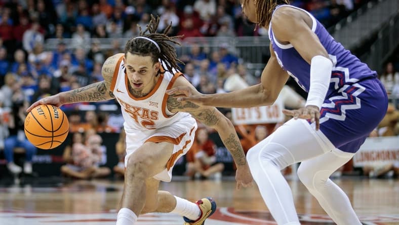 Mar 10, 2023; Kansas City, MO, USA; Texas Longhorns forward Christian Bishop (32) looks to drive around TCU Horned Frogs forward Xavier Cork (12) during the first half at T-Mobile Center. Mandatory Credit: William Purnell-USA TODAY Sports