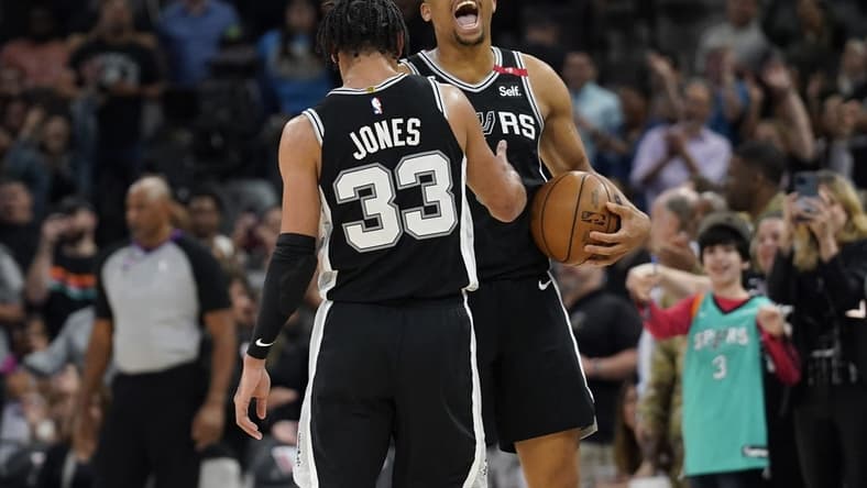Mar 10, 2023; San Antonio, Texas, USA; San Antonio Spurs forward Keldon Johnson (3) and guard Tre Jones (33) react after a victory over the Denver Nuggets at AT&T Center. Mandatory Credit: Scott Wachter-USA TODAY Sports