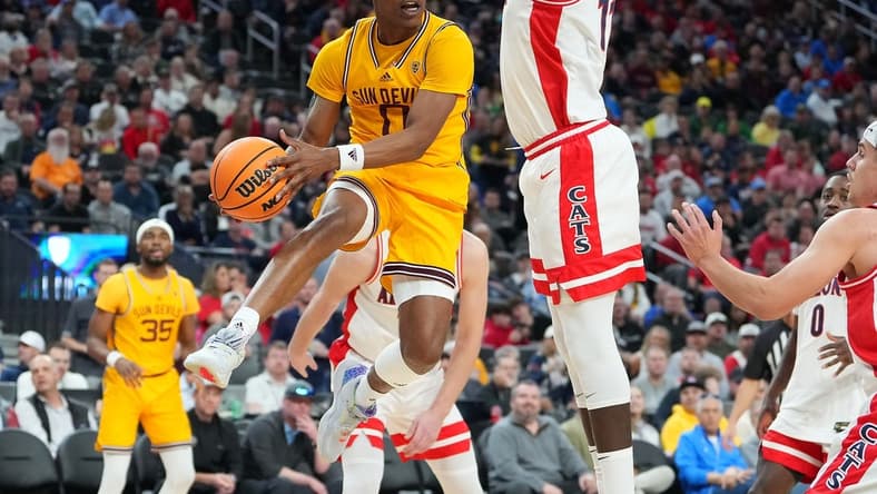 Mar 10, 2023; Las Vegas, NV, USA; Arizona State Sun Devils guard DJ Horne (0) looks to make a pass around Arizona Wildcats center Oumar Ballo (11) during the first half at T-Mobile Arena. Mandatory Credit: Stephen R. Sylvanie-USA TODAY Sports