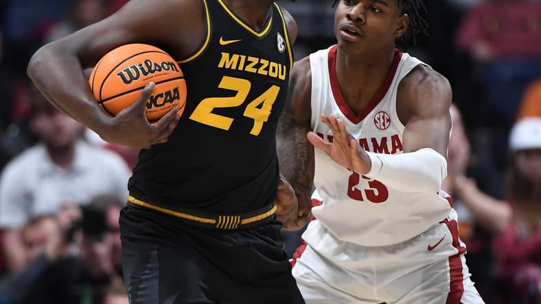 Mar 11, 2023; Nashville, TN, USA; Missouri Tigers guard Kobe Brown (24) is defended by Alabama Crimson Tide forward Nick Pringle (23) during the first half at Bridgestone Arena. Mandatory Credit: Christopher Hanewinckel-USA TODAY Sports