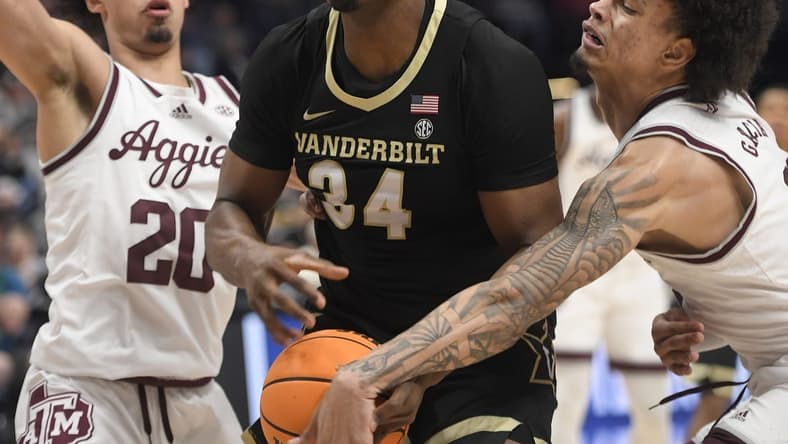 Mar 11, 2023; Nashville, TN, USA;  Texas A&M Aggies forward Andersson Garcia (11) slaps the ball from Vanderbilt Commodores forward Lee Dort (34) during the first half at Bridgestone Arena. Mandatory Credit: Steve Roberts-USA TODAY Sports