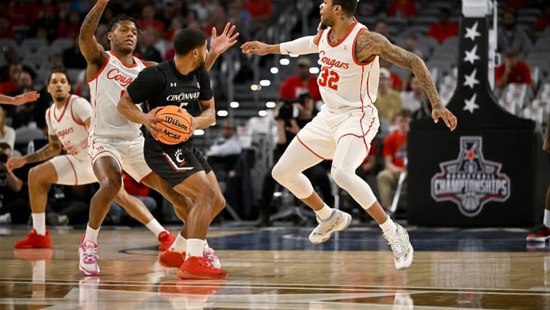 Mar 11, 2023; Fort Worth, TX, USA; Houston Cougars guard Marcus Sasser (0) and forward Reggie Chaney (32) defend against Cincinnati Bearcats guard David DeJulius (5) during the first half at Dickies Arena. Mandatory Credit: Jerome Miron-USA TODAY Sports