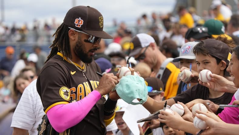 Mar 11, 2023; Peoria, Arizona, USA; San Diego Padres right fielder Fernando Tatis Jr. (23) signs autographs before a game against the Chicago White Sox at Peoria Sports Complex. Mandatory Credit: Rick Scuteri-USA TODAY Sports
