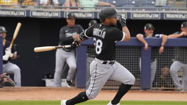 Mar 11, 2023; Peoria, Arizona, USA; Chicago White Sox second baseman Leury Garcia (28) hits against the San Diego Padres in the third inning at Peoria Sports Complex. Mandatory Credit: Rick Scuteri-USA TODAY Sports
