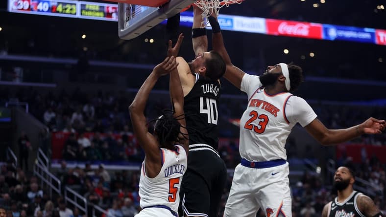 Mar 11, 2023; Los Angeles, California, USA;  Los Angeles Clippers center Ivica Zubac (40) fights for a rebound against New York Knicks center Mitchell Robinson (23) during the second quarter at Crypto.com Arena. Mandatory Credit: Kiyoshi Mio-USA TODAY Sports