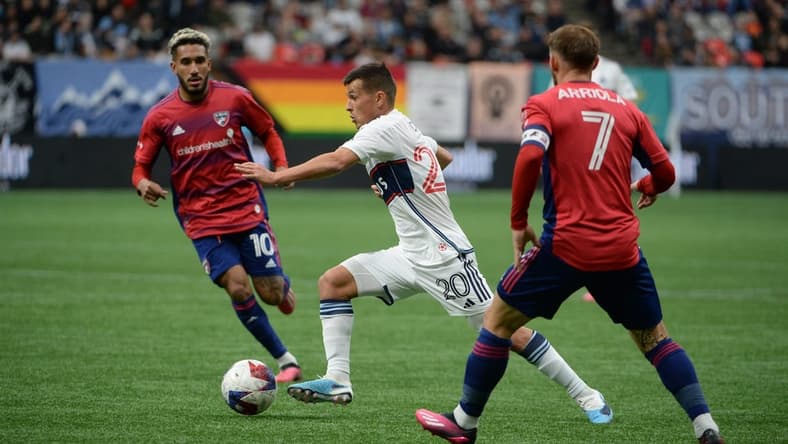 Mar 11, 2023; Vancouver, British Columbia, CAN; Vancouver Whitecaps midfielder Andres Cubas (20) dribbles the ball against FC Dallas forward Jesus Ferreira (10) during the first half at BC Place. Mandatory Credit: Anne-Marie Sorvin-USA TODAY Sports