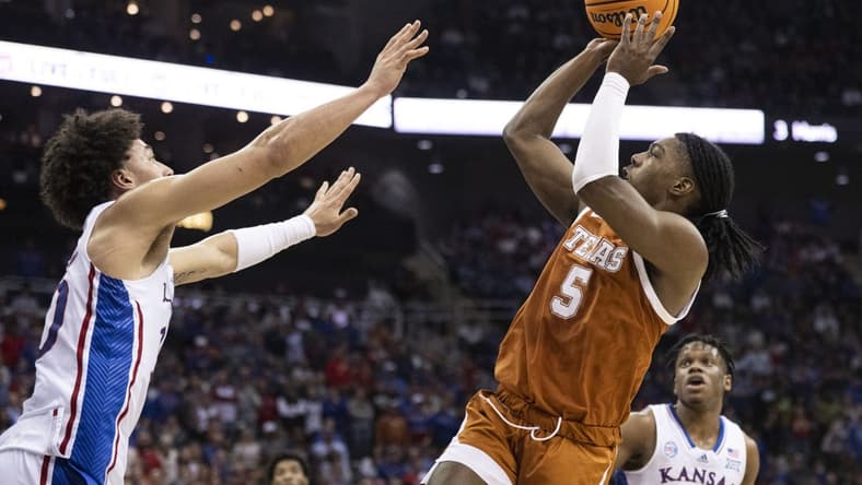 Mar 11, 2023; Kansas City, MO, USA; Texas Longhorns guard Marcus Carr (5) shoots the ball against Kansas Jayhawks forward Jalen Wilson (10) in the first half at T-Mobile Center. Mandatory Credit: Amy Kontras-USA TODAY Sports