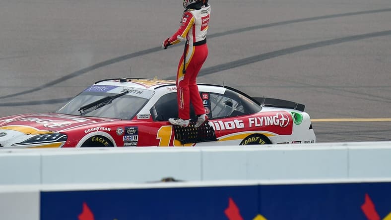Mar 11, 2023; Avondale, Arizona, USA; NASCAR Xfinity Series driver Sammy Smith (18) celebrates his victory of  the United Rentals 200 at Phoenix Raceway. Mandatory Credit: Gary A. Vasquez-USA TODAY Sports