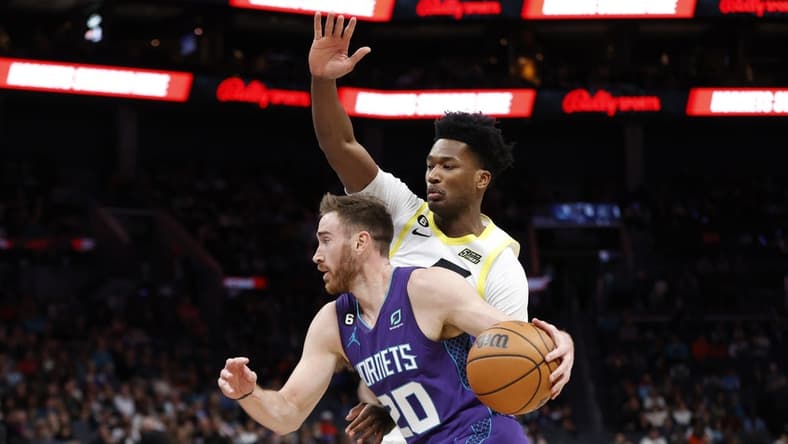 Mar 11, 2023; Charlotte, North Carolina, USA; Charlotte Hornets forward Gordon Hayward (20) drives past Utah Jazz center Damian Jones (15) during the first quarter at Spectrum Center. Mandatory Credit: Brian Westerholt-USA TODAY Sports