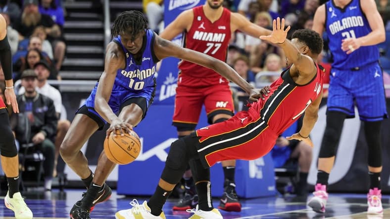 Mar 11, 2023; Orlando, Florida, USA; Orlando Magic center Bol Bol (10) handles the ball against Miami Heat guard Kyle Lowry (7) during the second quarter at Amway Center. Mandatory Credit: Mike Watters-USA TODAY Sports